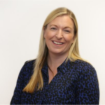A photograph of a blonde lady smiling at the camera, her name is Louise McCathie